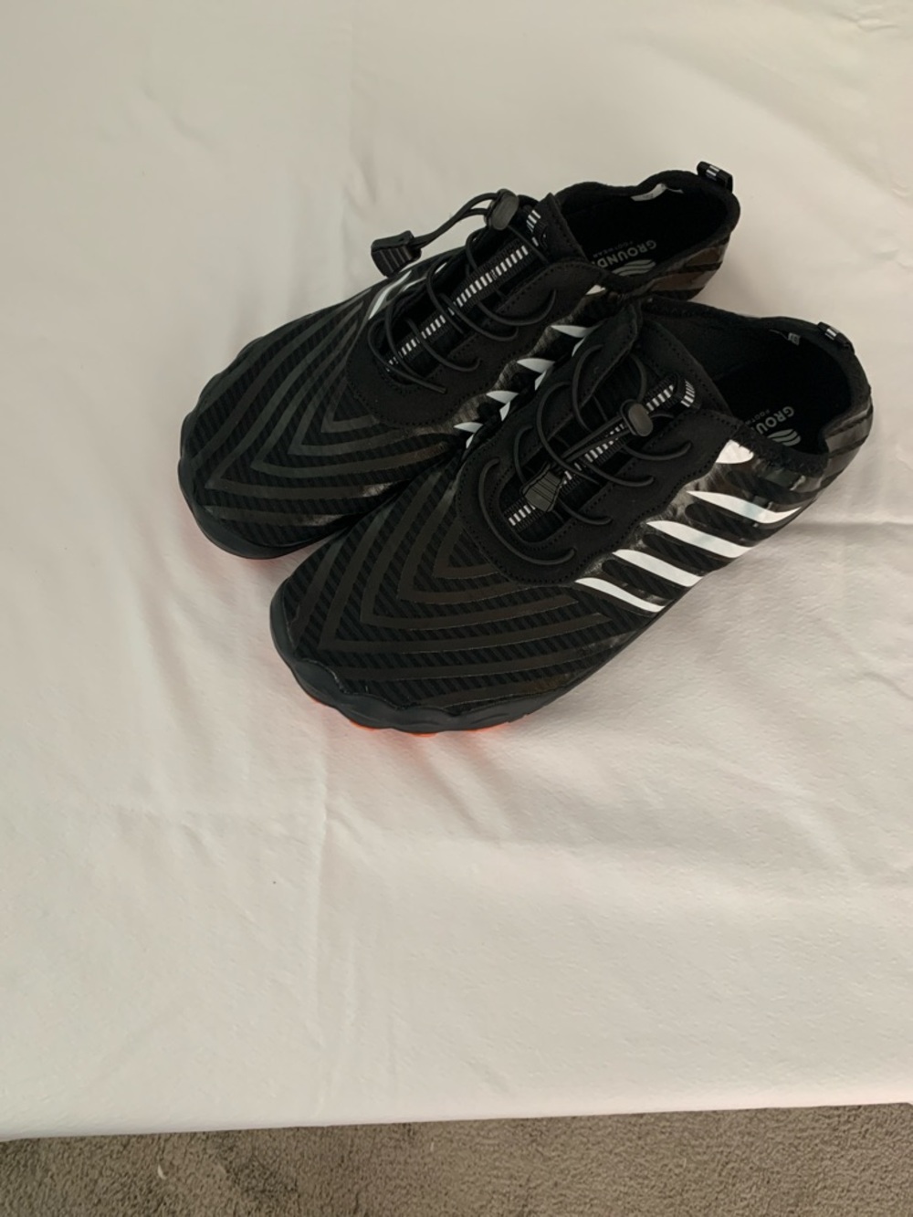 Mens Grounded Footwear Black Athletic Slip-On Shoes with Reflective Stripes.